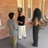 Jenna Rickus speaks with a student and a colleague outside of Old Main